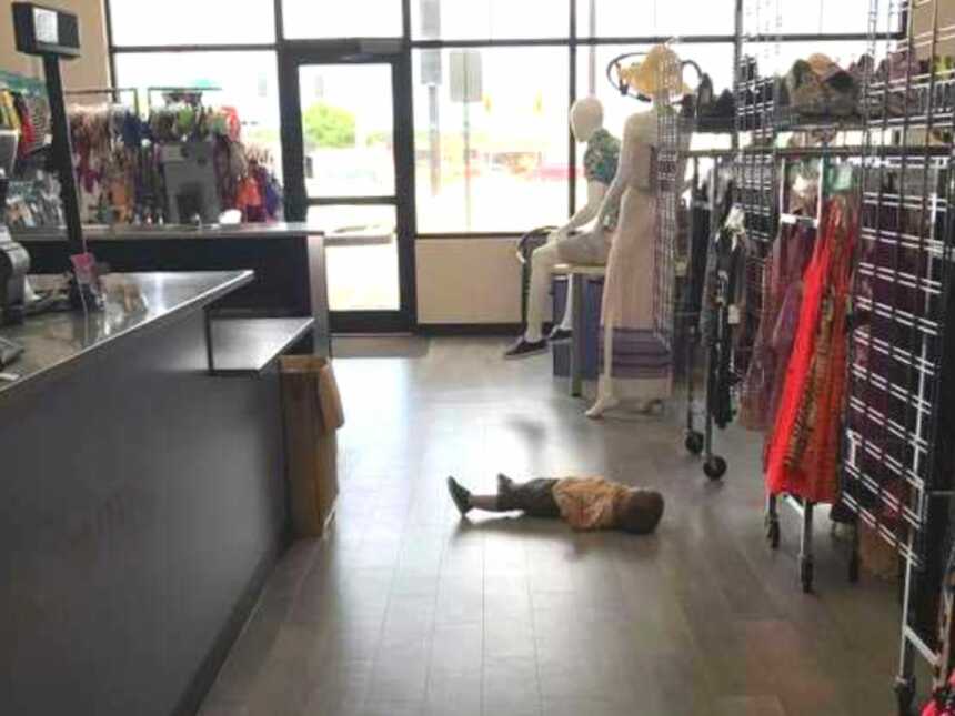 Toddler lying down on retail store floor