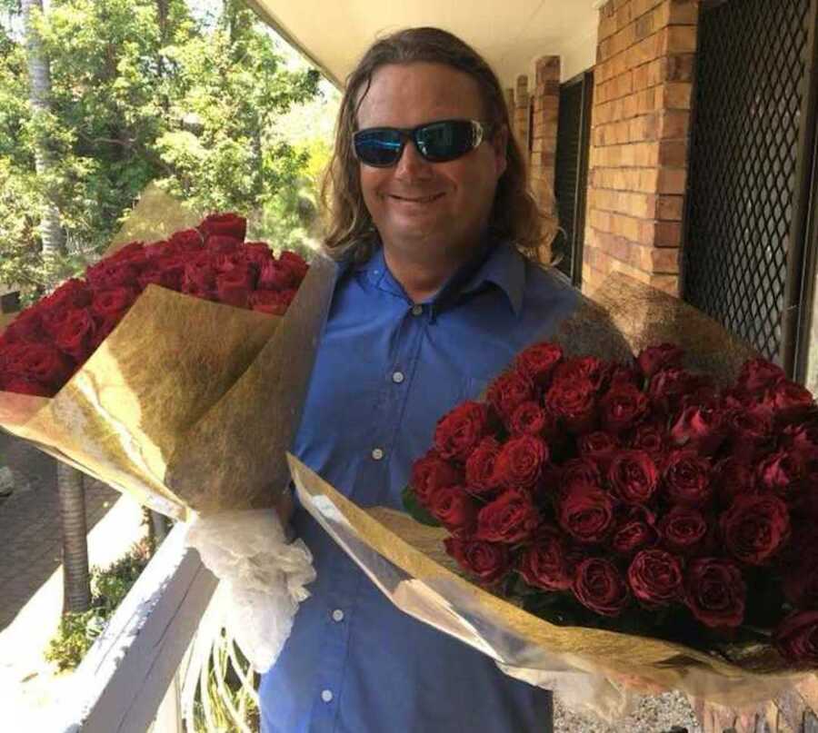 man holding bouquets of roses