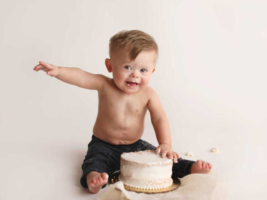 toddler with down syndrome with cake