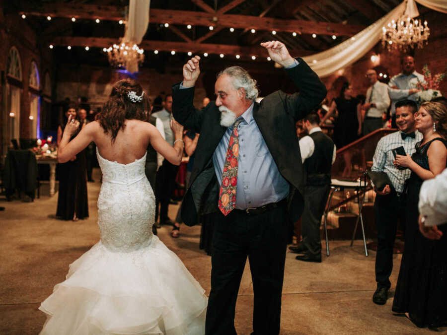 Daughter and stepdaughter dance at wedding together 