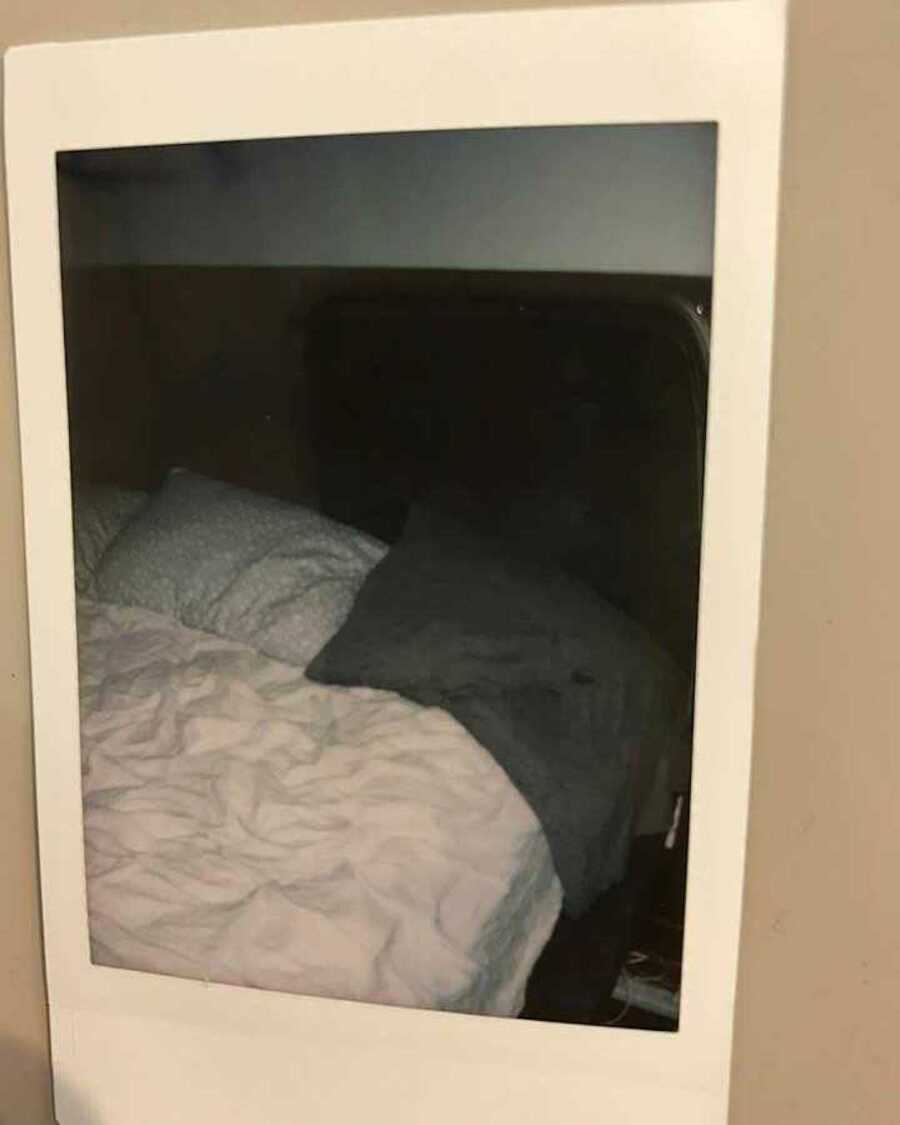Polaroid of made bed