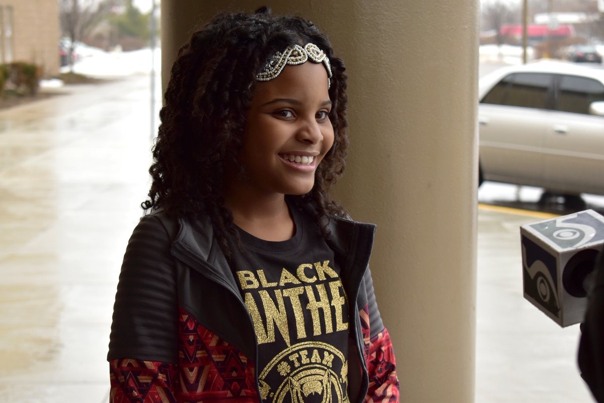 young girl in black panther shirt, working to make change in Flint, Michigan