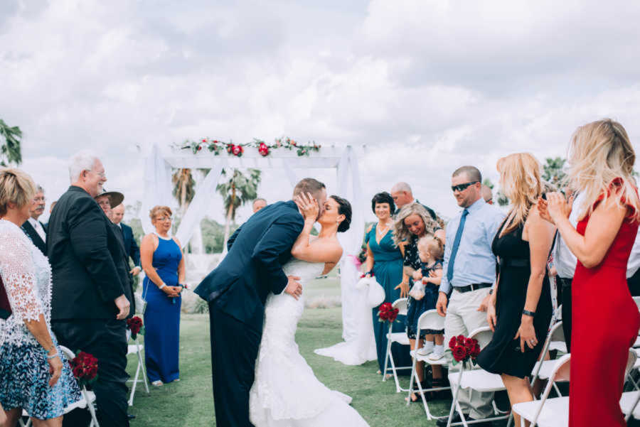 married couple kissing at their wedding