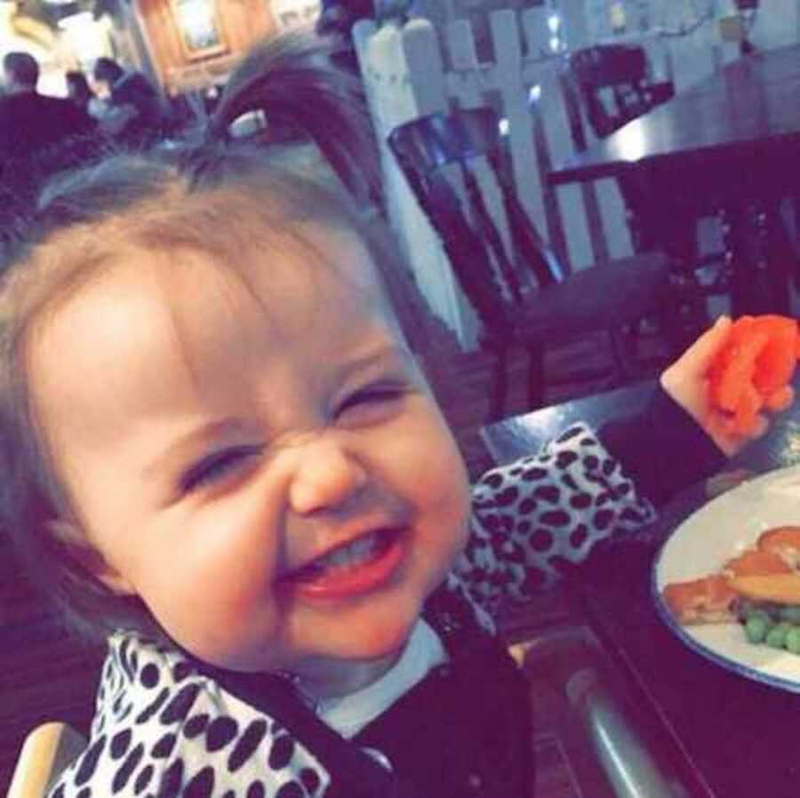Infant smiling at table eating before she passed away