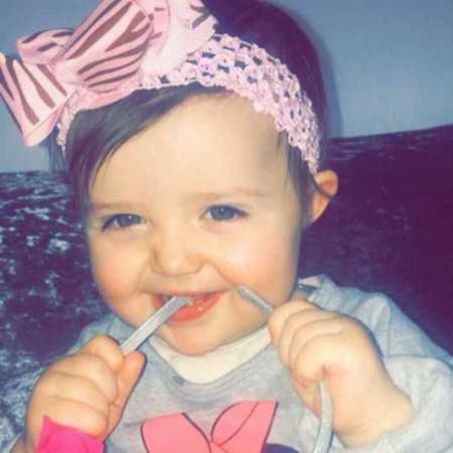 Infant who has since passed away from suffocating on teddy bear biting headband