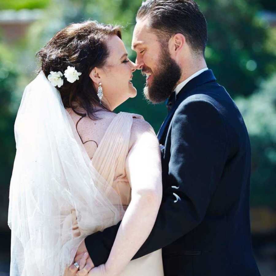 couple takes photo in wedding attire after weight loss