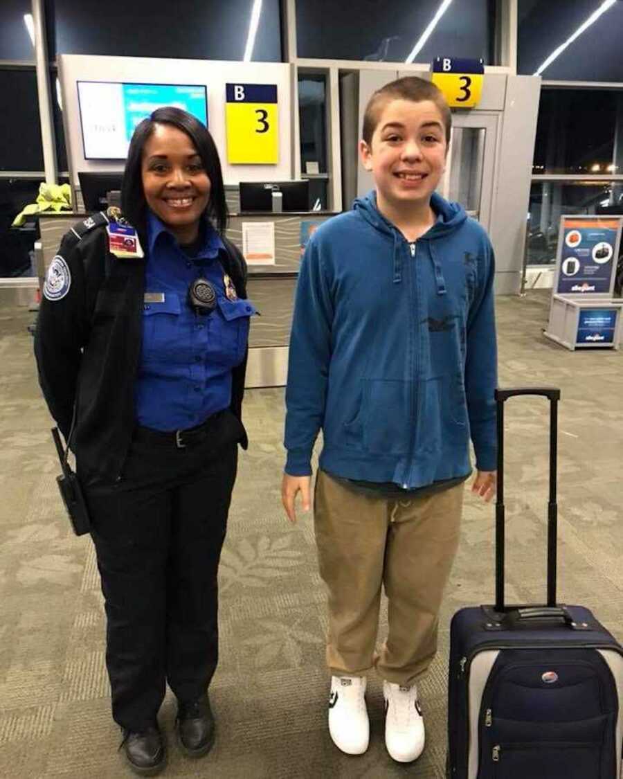 tsa agent smiles standing next to teen boy with autism