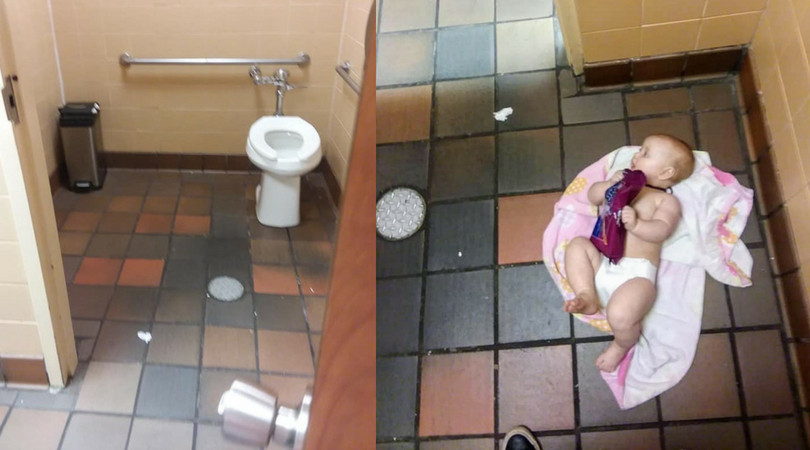 baby girl laid on pink blanket on the floor of a public men's restroom