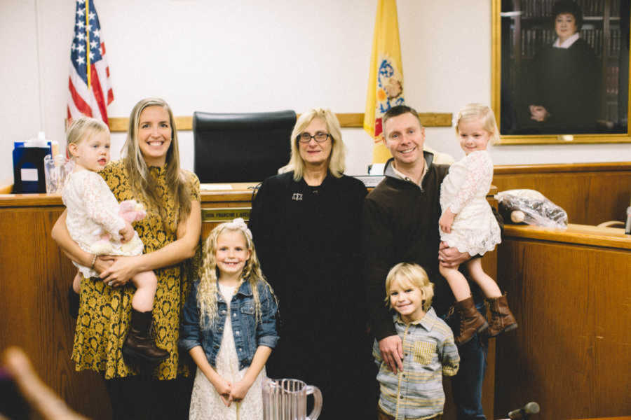 parents smiling in court with 4 children