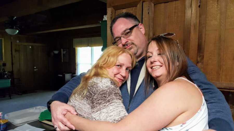 adopted son hugging bio mom and sister