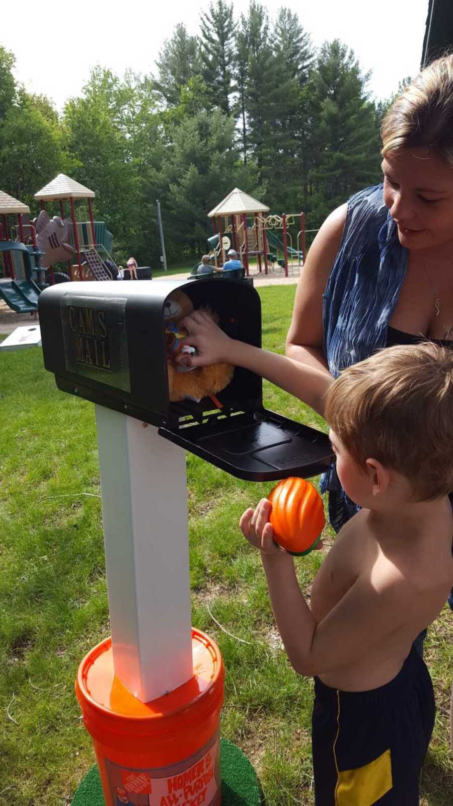 young bot with autism pulls toys out of mailbox made by Home Depot employees