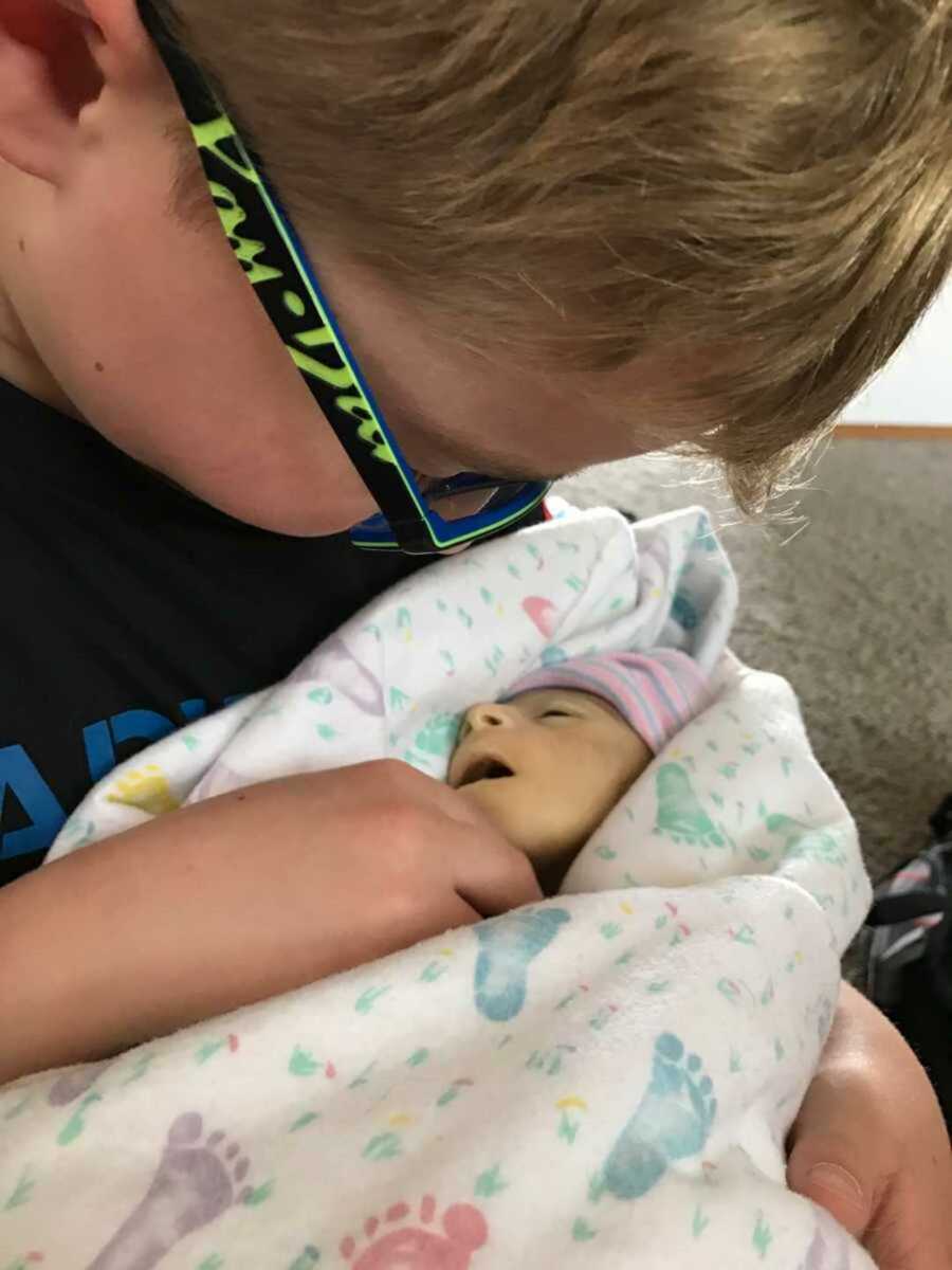 Big brother holds his deceased baby brother for the last time 