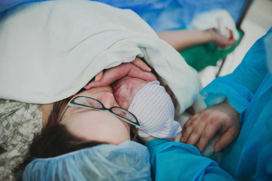 Mom embraces newborn son after having a c-section delivery