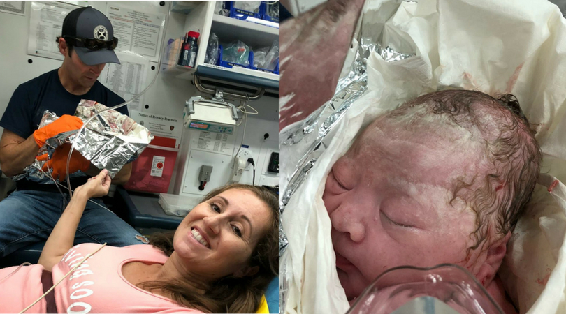Postpartum mom smiling inside ambulance alongside husband and newborn