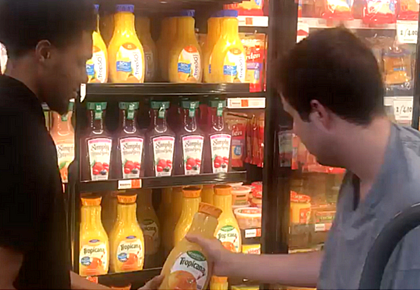 Rouses Market employee helping teen with autism stock shelves