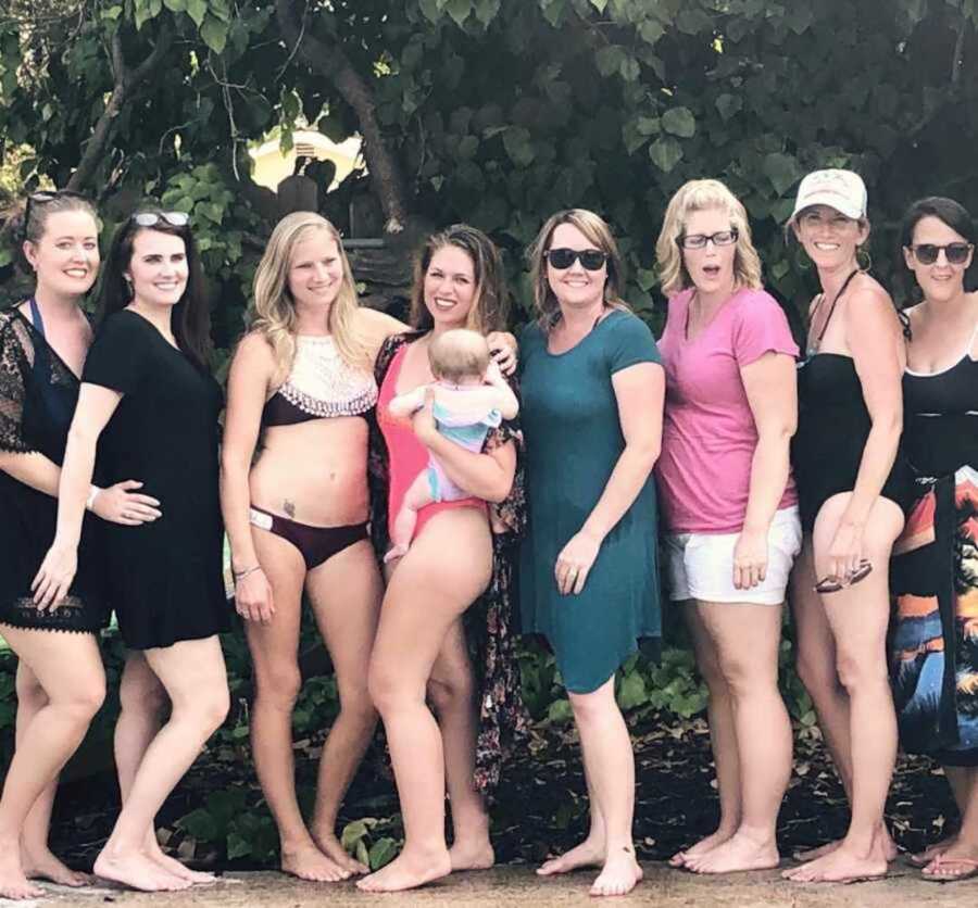group of moms who met online through a support group standing together on a trip