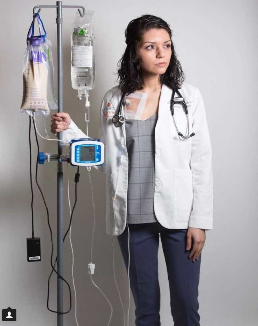 Confident med student posing with white coat and medical supplies