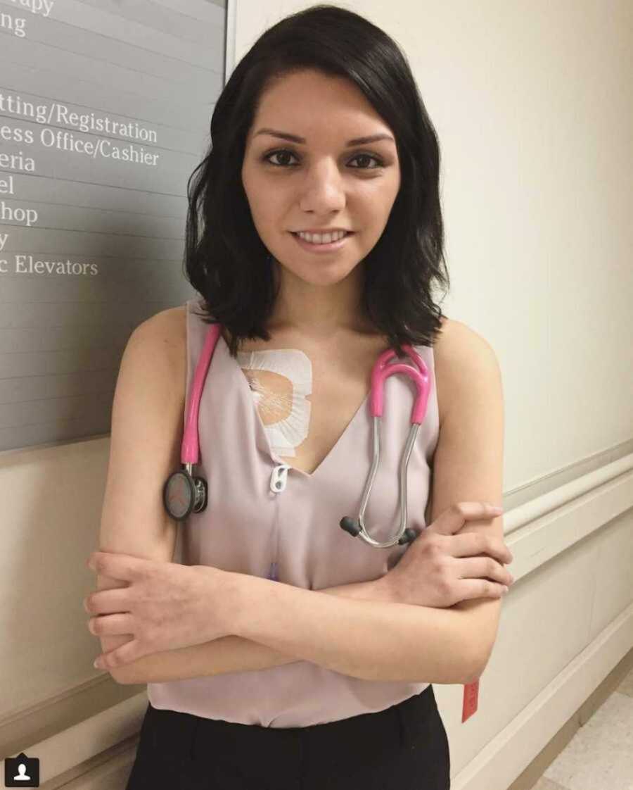 Smiling med student crossing her arms with stethescope 
