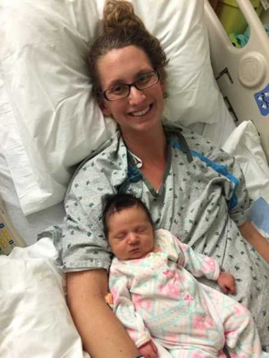 Woman who died at childbirth but brought back to life lays in hospital bed with newborn