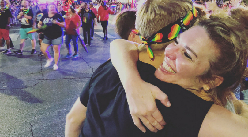 Woman hugging teen at Austin Pride Parade