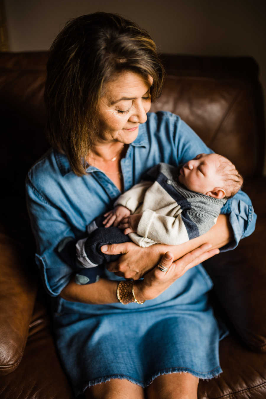 Grandma holding newborn son