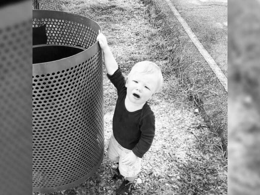 toddler crying by trash can