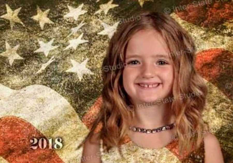 Little girl's head floating on American Flag from wearing green dress that blends in with green screen