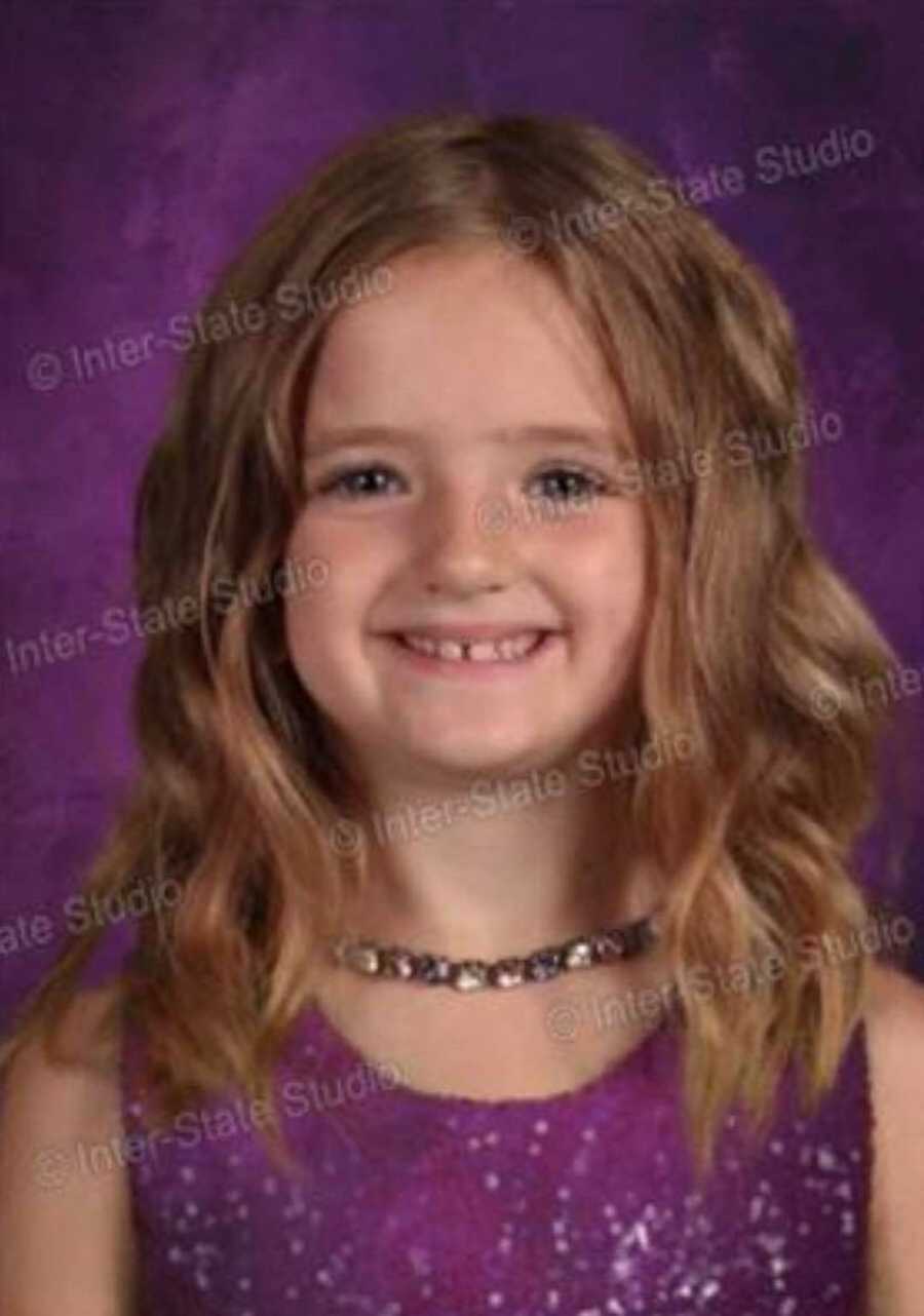 Little girl's head floating in purple background from wearing green dress that blends in with green screen