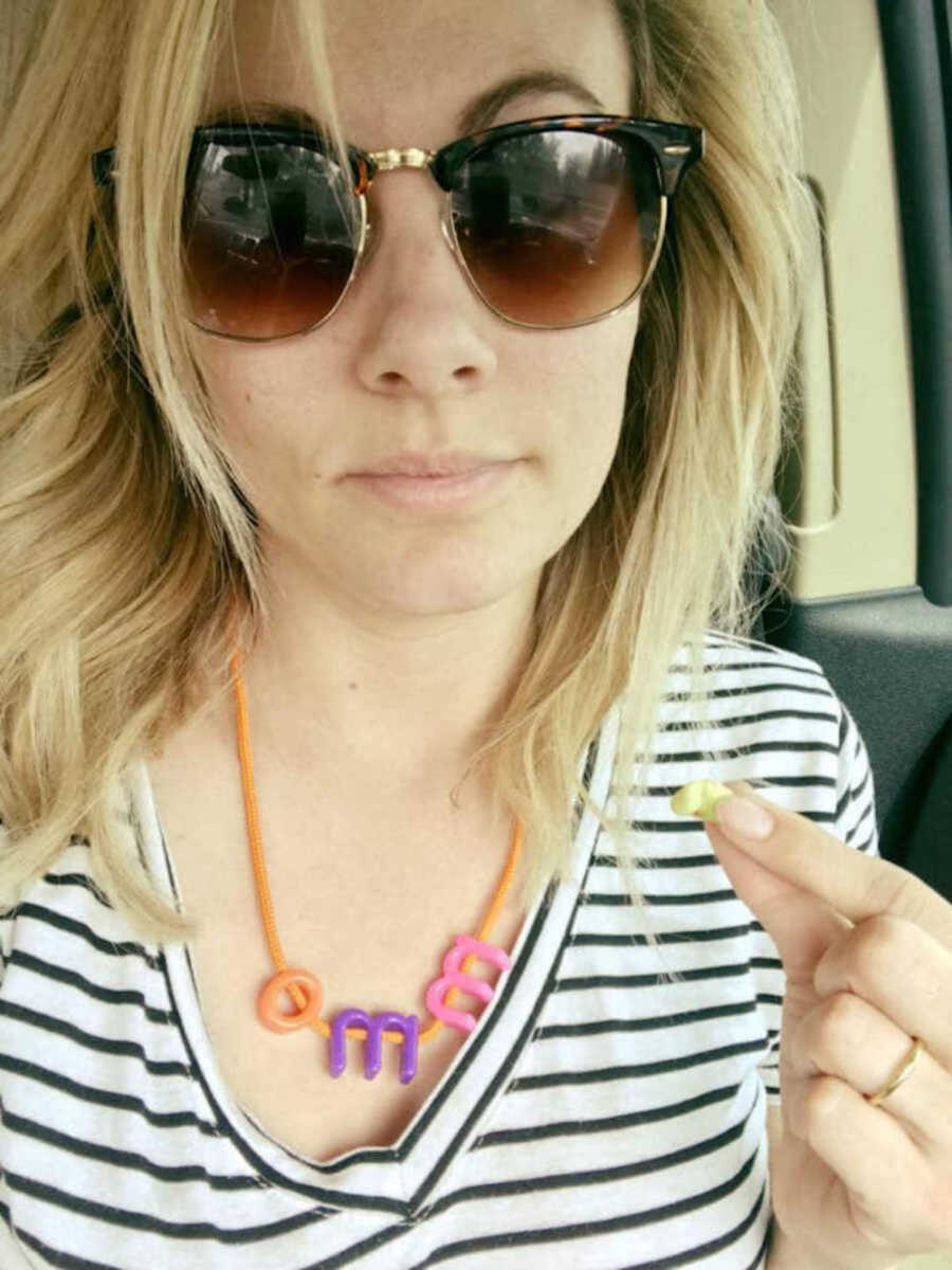 mom in sunglasses takes selfie in car