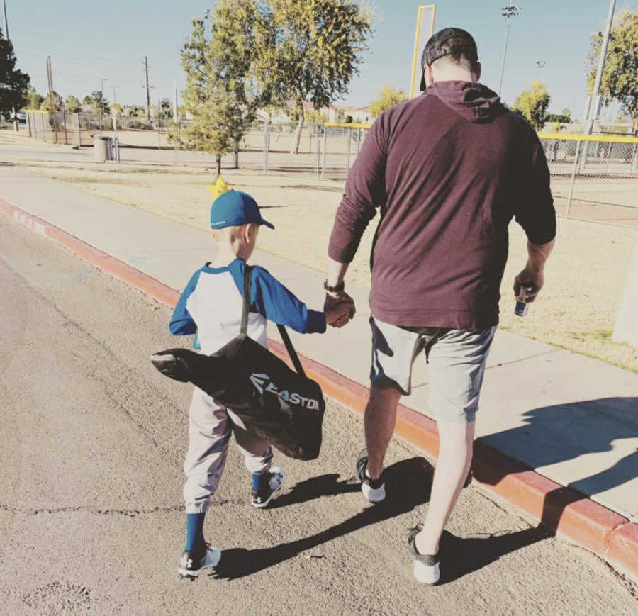 dad and son walking with sports bag