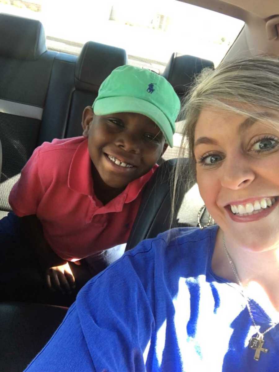 Foster mom smiling with foster son inside car