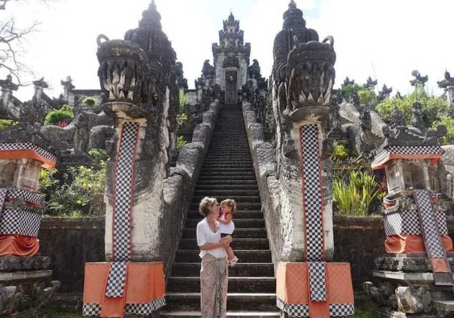 mom holding baby while traveling