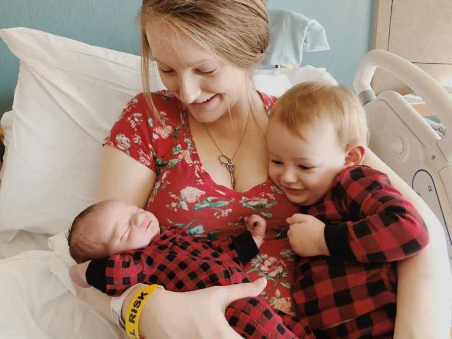 mom holds two children in hospital bed