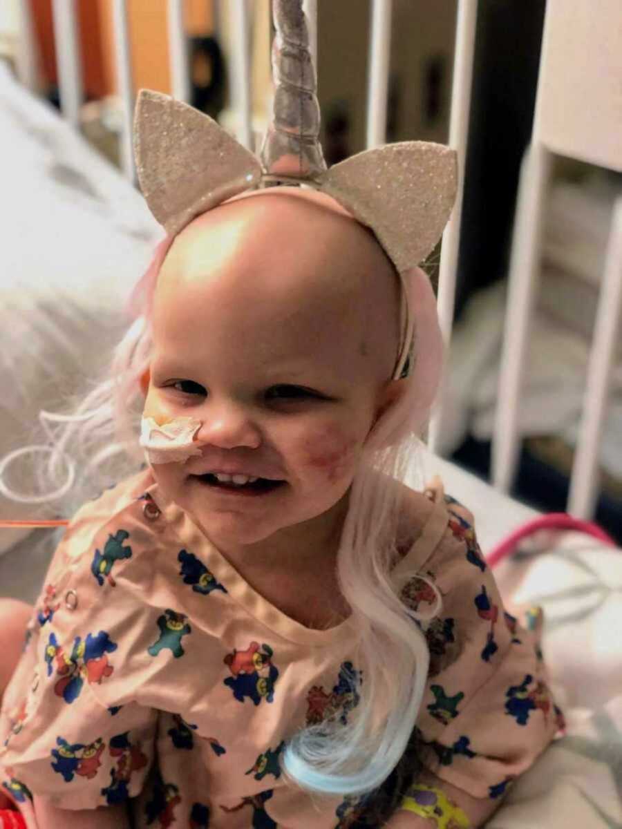 young girl in hospital bed after chemo