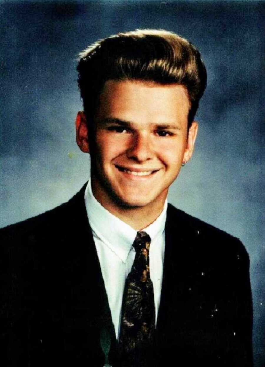 High school yearbook photo of blonde teen in suit