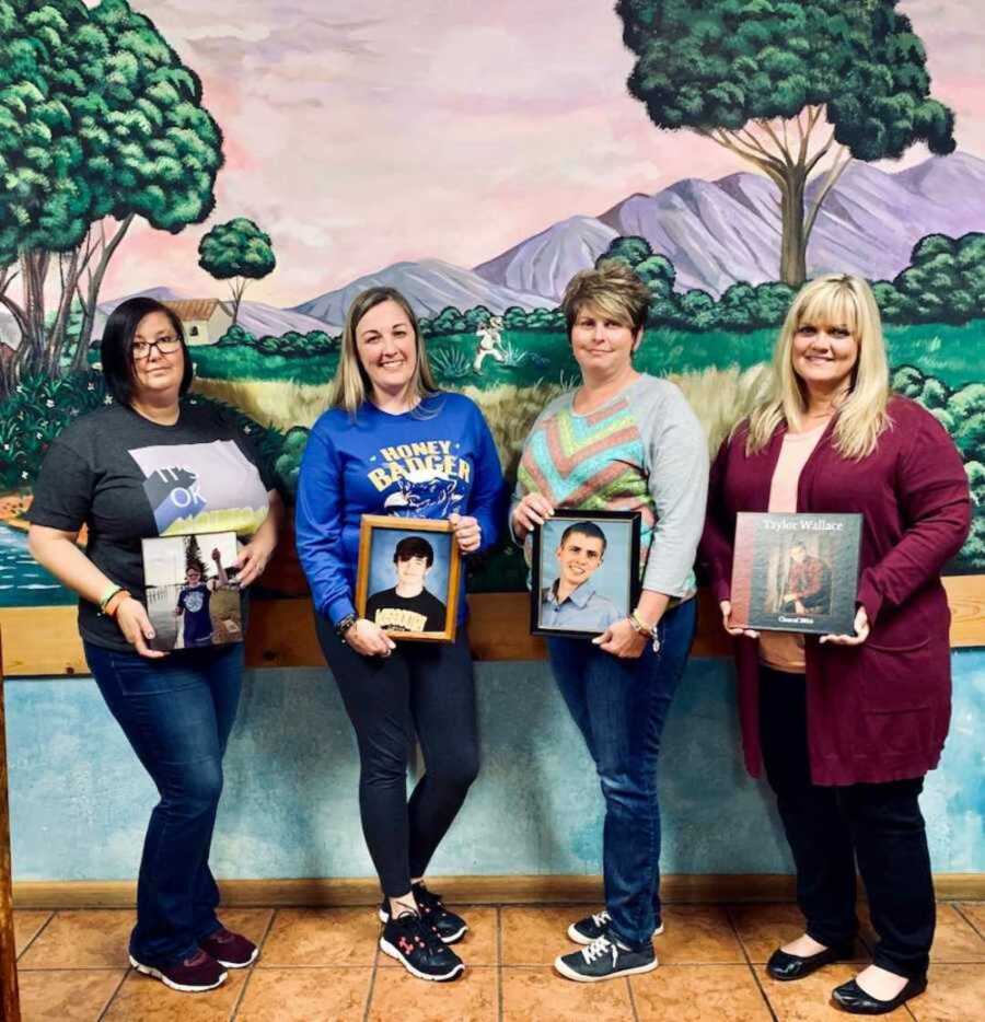 four mothers stand holding images of their children who they lost to suicide