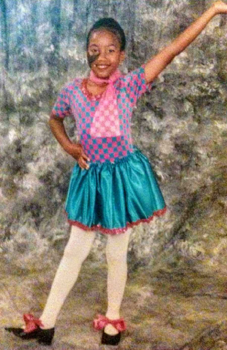 Girl posing in pink and blue dance attire