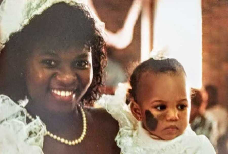 Mom in wedding dress holding daughter with nevus birthmark