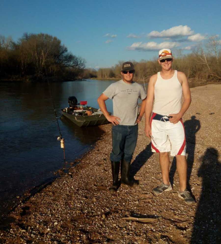 brothers stand by river