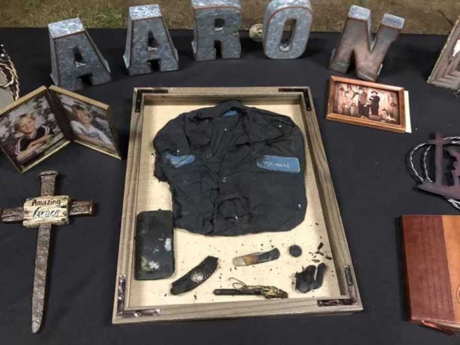 table with the word "Aaron" and belongings of deceased man