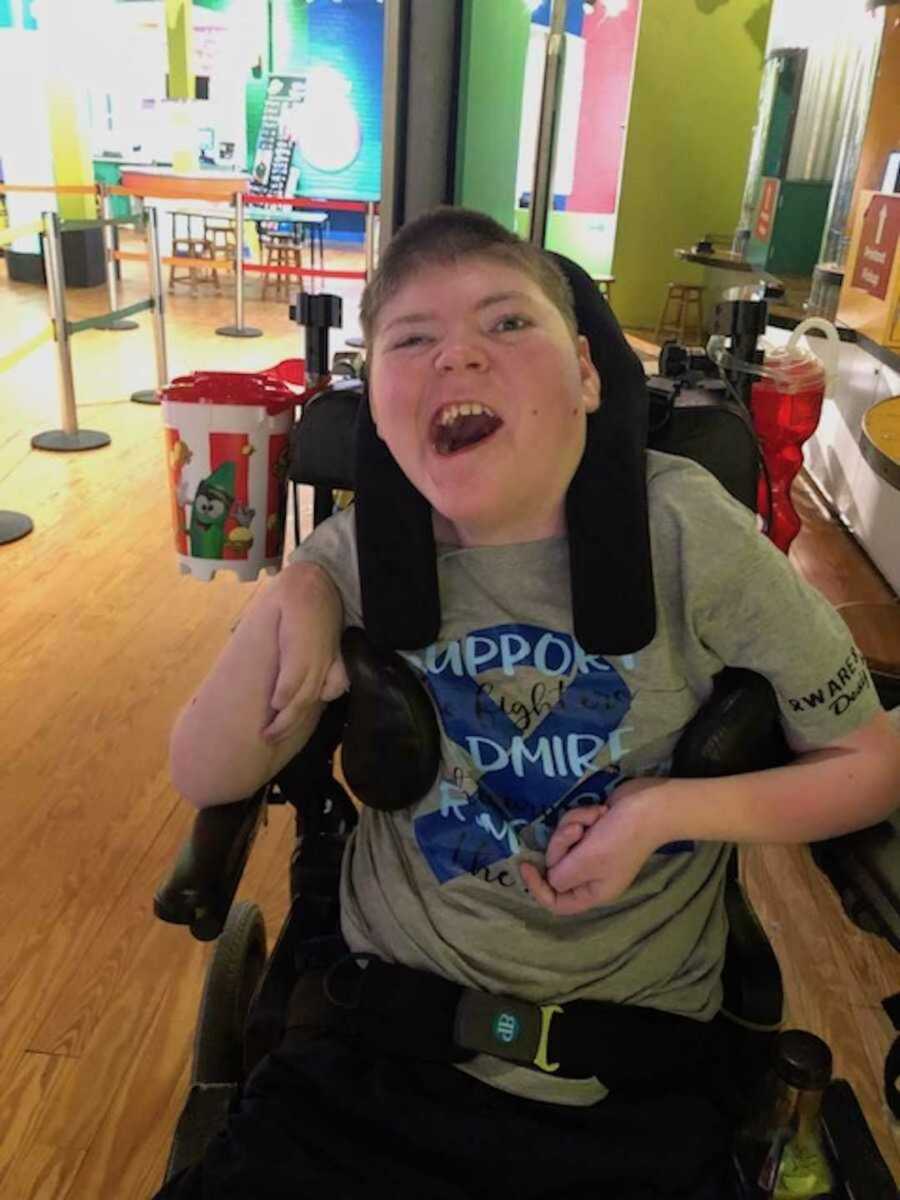 Disabled little boy in his chair with awareness shirt on