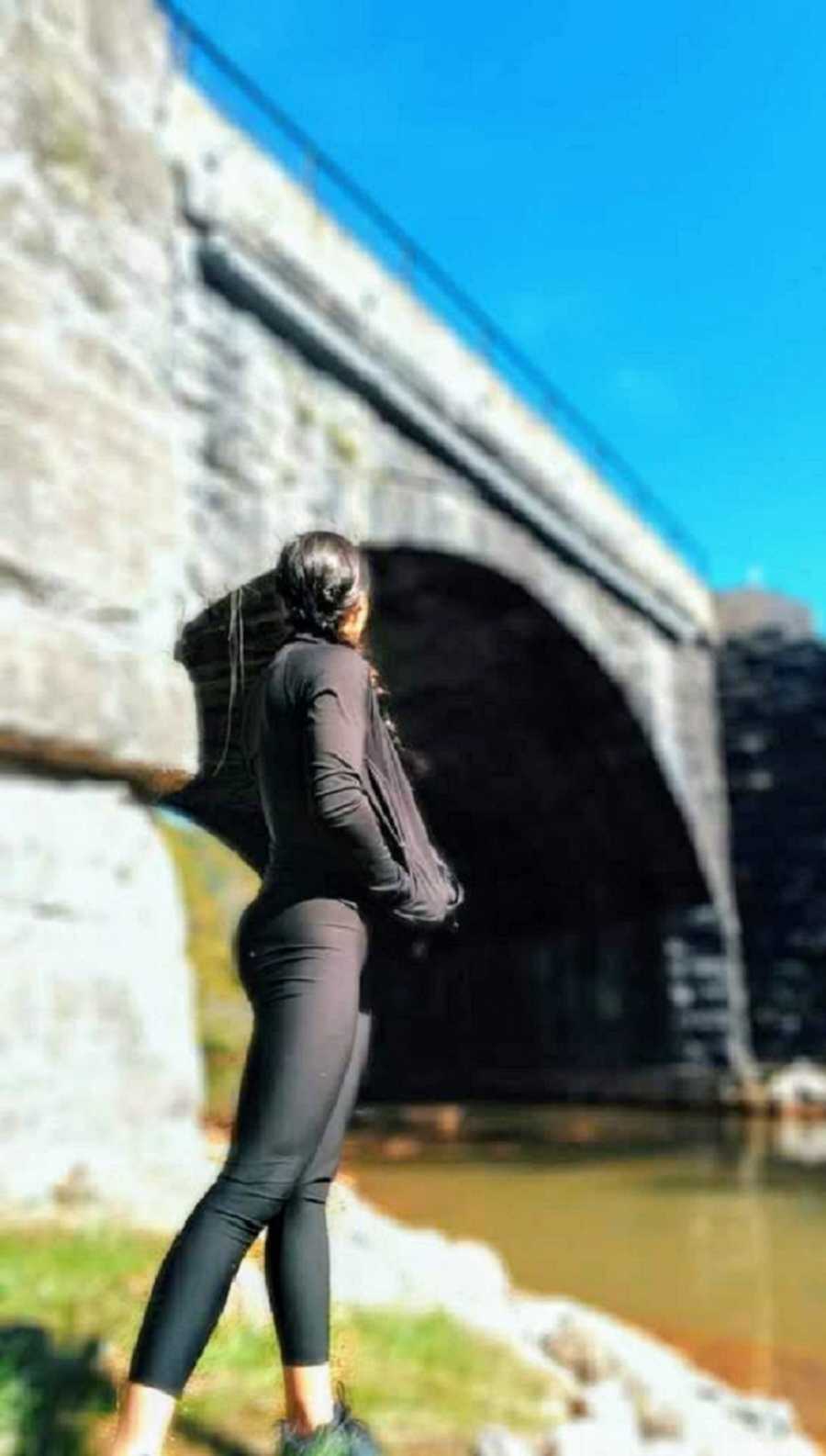 woman standing outside in black outfit