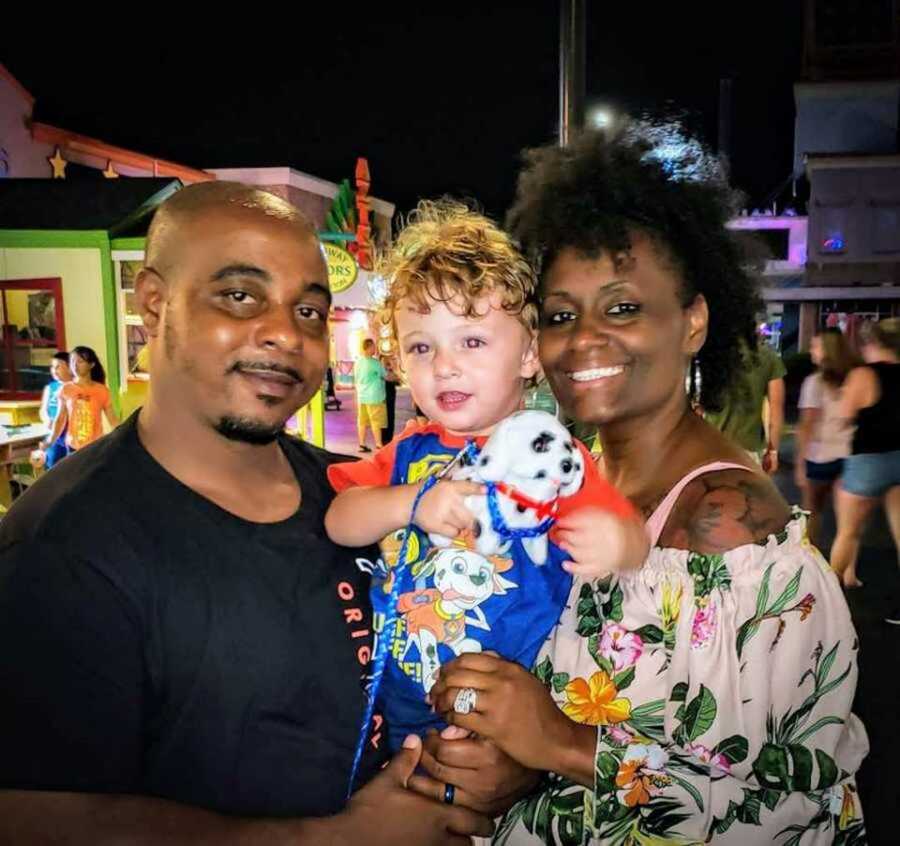 Adoptive parents holding toddler son