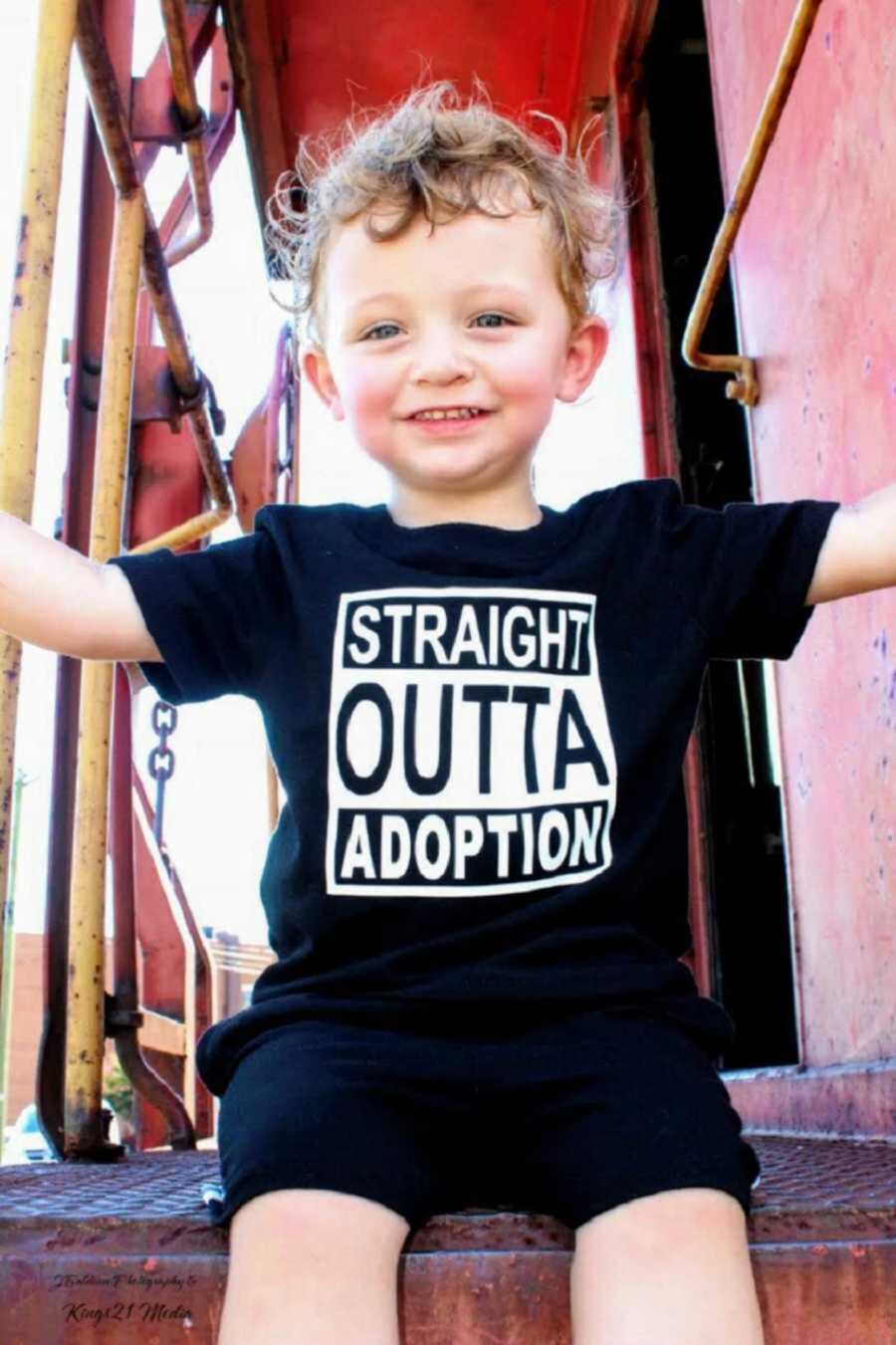 Adopted toddler wearing "straight outta adoption" shirt