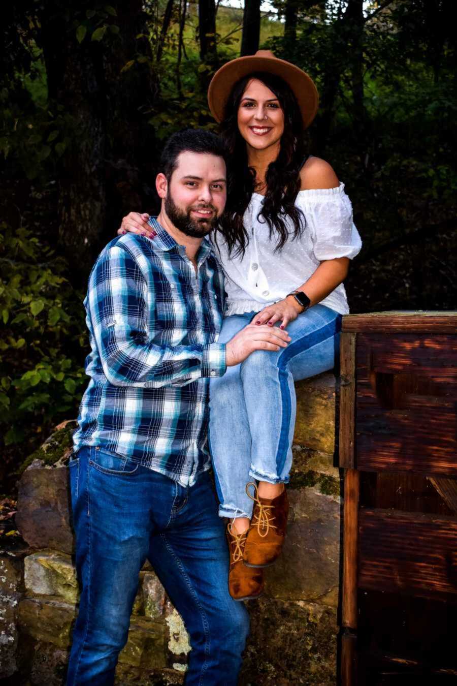 birth mom sits on box with her boyfriend next to her