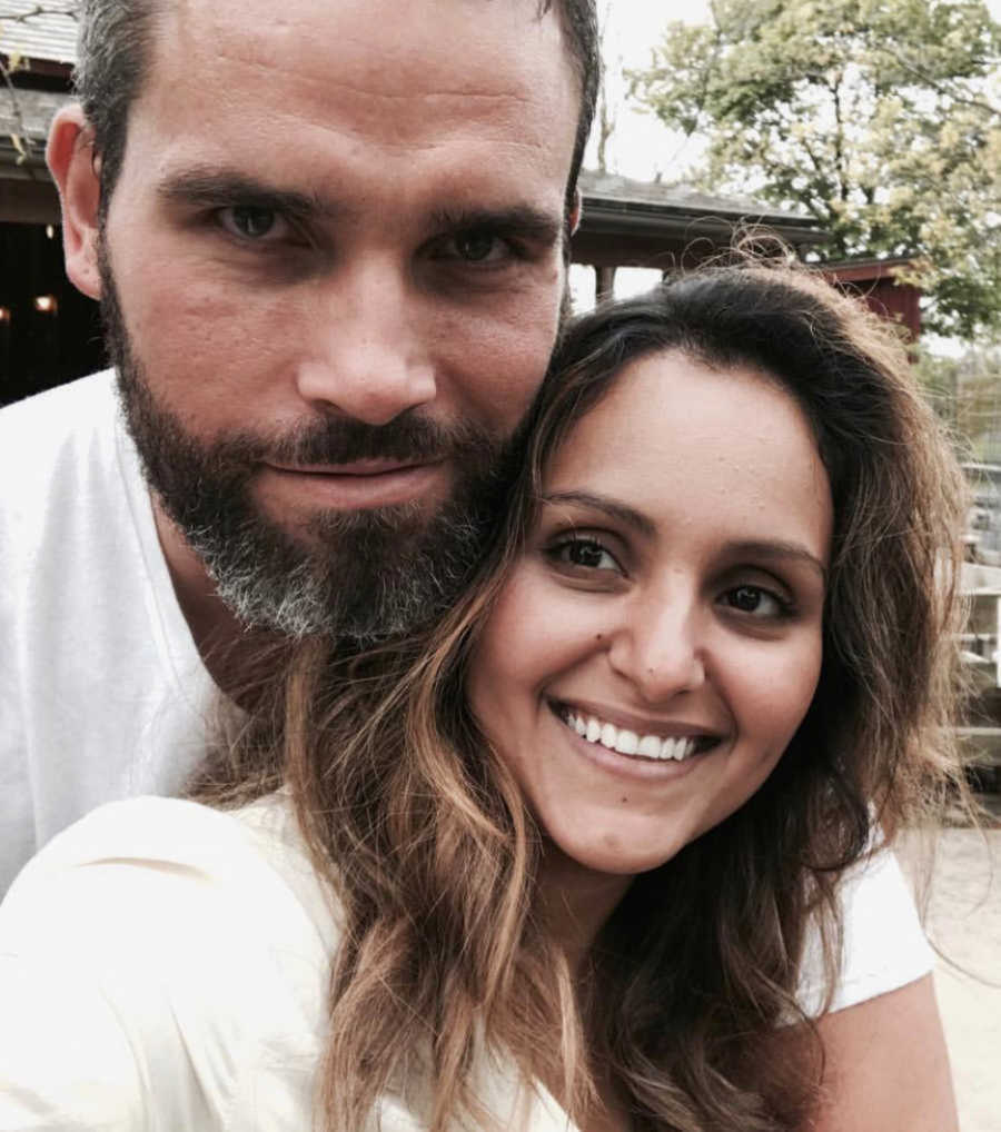 couple takes a selfie together while they are both wearing white