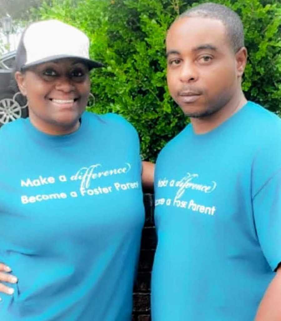 Couple wearing matching blue foster parent shirts