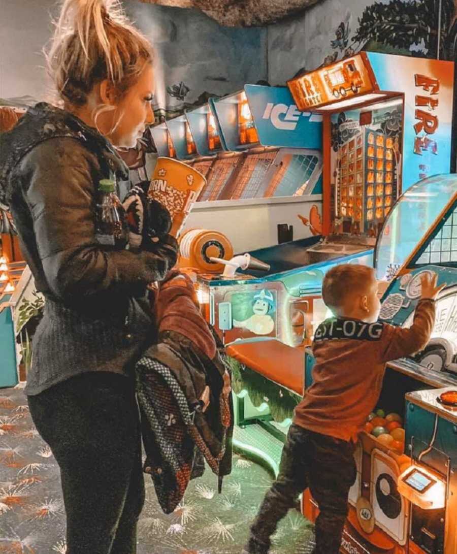 mom and child playing at arcade