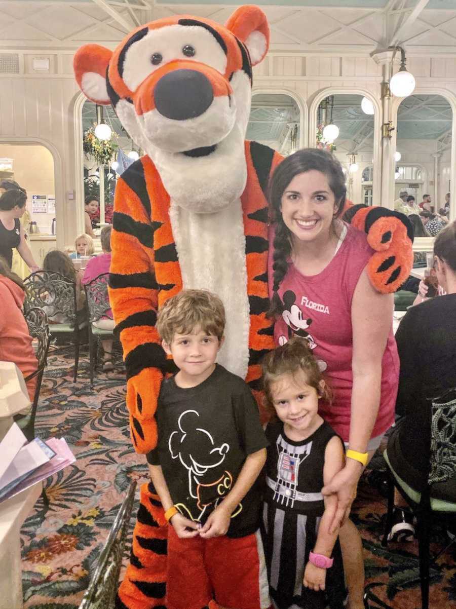 mom with her two children at a Disney character meal with Tigger