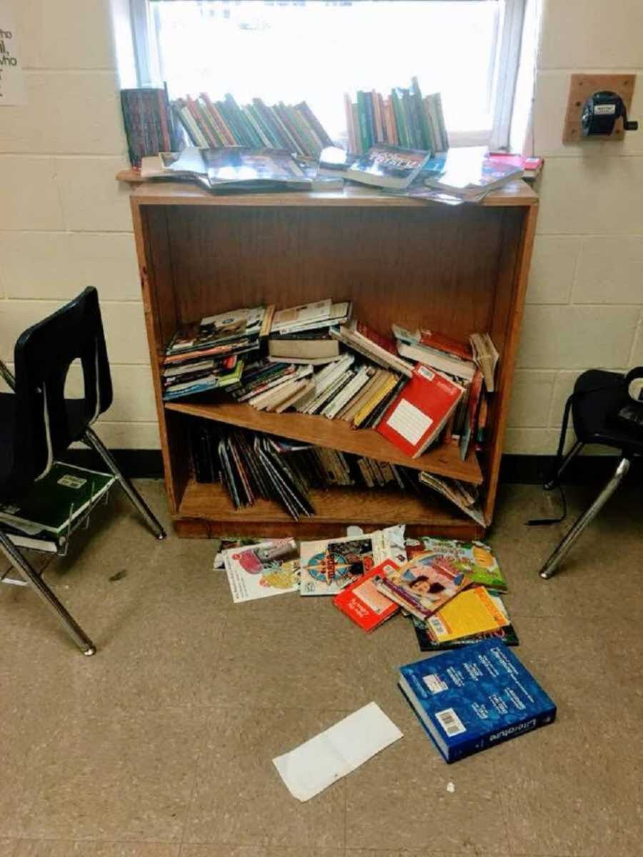 Broken classroom bookshelf with disorderly piles of books